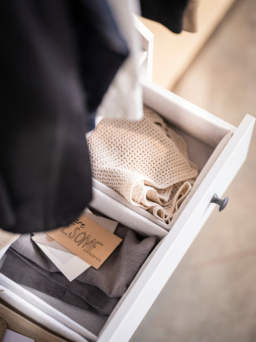  IKEA BAXNA grey white organiser inside open white dresser drawer with folded clothes and accessories