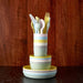 Stacked colorful ceramic plates with cutlery on a wooden surface