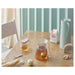  IKEA BEHÖVD light green vacuum flask with glass insert and silicone seal displayed with tea and ginger
