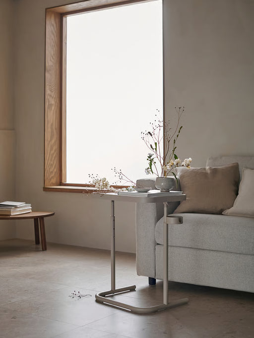 IKEA BJÖRKÅSEN beige stand showing the built-in cup holder clip and sturdy steel base