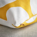 Close-up of IKEA BLÅMUNKAR yellow and white dot cushion cover showing cotton fabric and dot pattern detail