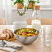 IKEA BLANDA BLANK bowl styled on wooden dining table with fruit salad bread and carafe
