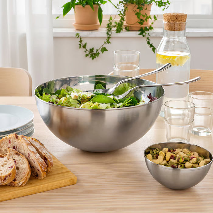 IKEA BLANDA BLANK stainless steel serving bowl filled with fresh green salad on a dining table