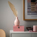 Ombre-style IKEA BLODBJÖRK ceramic vase transitioning from pale pink to blue, measuring 16 cm (6¼") high - an elegant accent piece for shelves, desks, or dining tables.