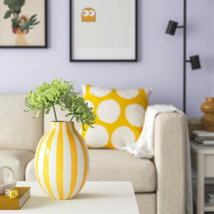 IKEA BLODBJÖRK yellow striped vase with green succulents on table beside sofa and polka dot pillow