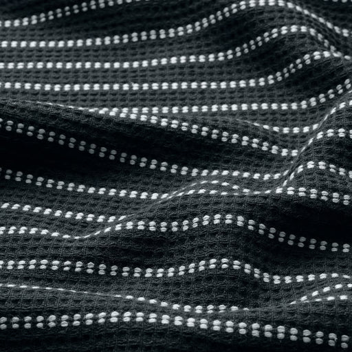 Close-up of IKEA BROKGINST black waffle-weave towel showing detailed cotton texture