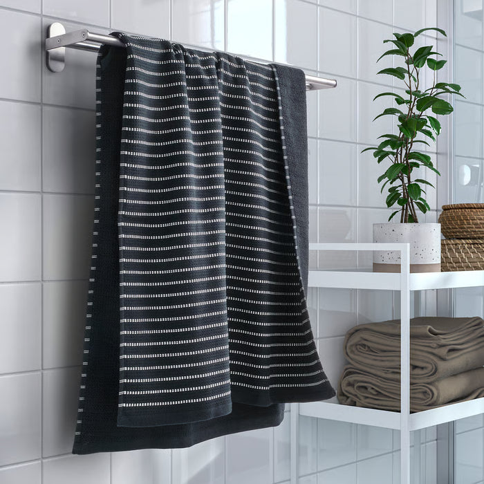 IKEA BROKGINST black towel hanging in modern tiled bathroom near window