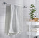  IKEA BROKGINST white bath towels hanging on hooks displaying both fabric textures