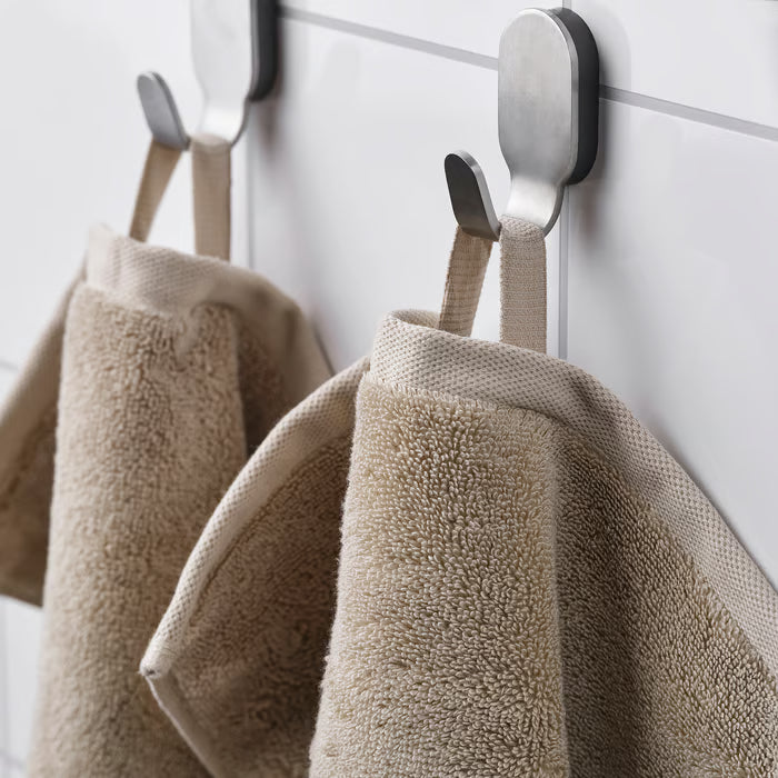  Close-up of IKEA BROKGLIM beige bath towel soft plush organic cotton texture and woven border