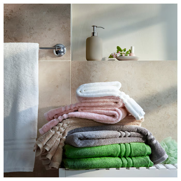IKEA BROKGLIM beige bath towel draped and styled in a bathroom setting