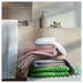 IKEA BROKGLIM beige bath towel draped and styled in a bathroom setting