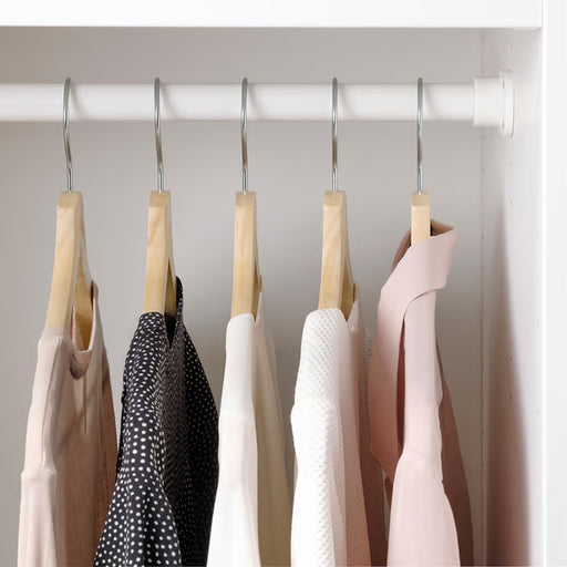 IKEA BUMERANG wooden hangers holding garments neatly organised inside a wardrobe
