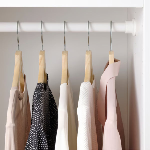 IKEA BUMERANG wooden hangers holding garments neatly organised inside a wardrobe