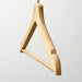 Close-up of IKEA BUMERANG wooden hanger showing grooves and chrome-plated steel hook