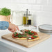 An eco-friendly and sustainable bamboo chopping board from IKEA, featuring a stylish design-80570671