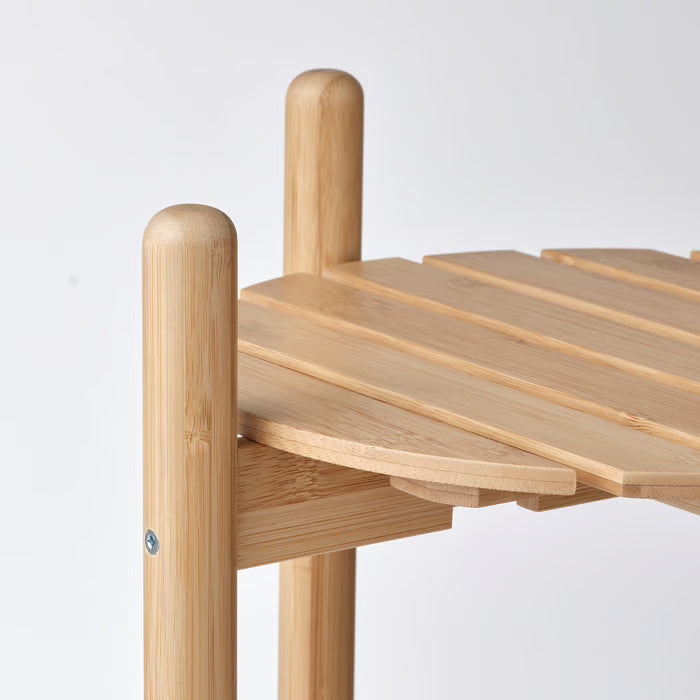 Close-up of IKEA DAKSJUS bamboo plant stand showing natural bamboo grain and clear lacquer finish