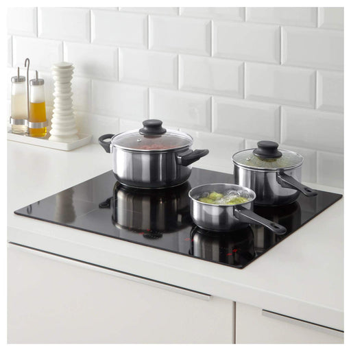 IKEA ANNONS stainless steel pot in use on a stove, with visible tempered glass lid and contents being cooked -ANNONS 3-Piece Cookware Set