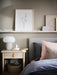 IKEA DEJSA lamp in modern minimalist room setup with beige chair and round side table