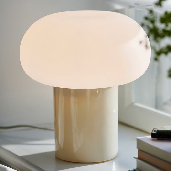 IKEA DEJSA table lamp close view showing rounded opal glass shade