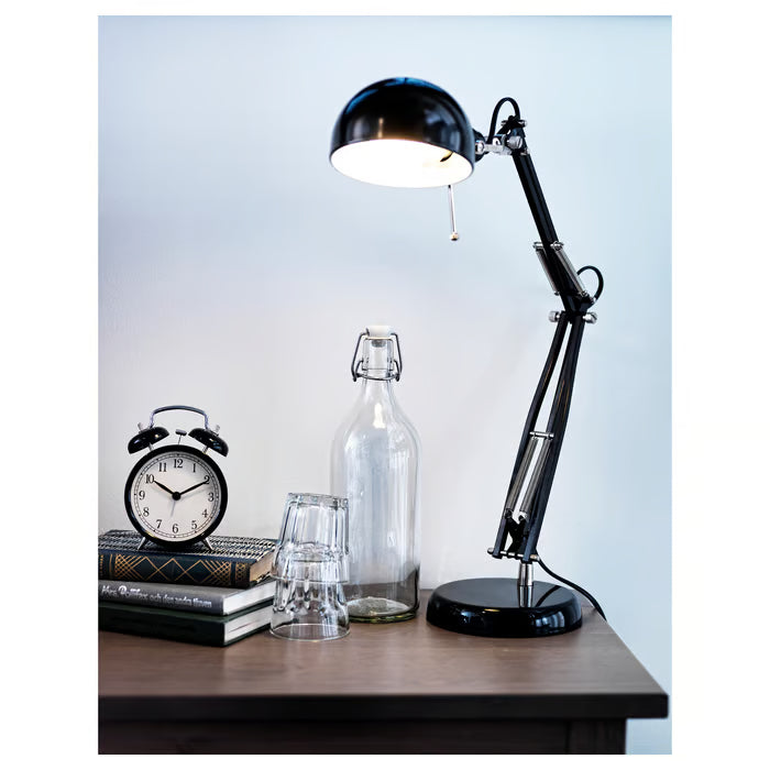  IKEA DEKAD black alarm clock on dark desk with lamp and glass decor items styled setup