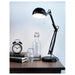  IKEA DEKAD black alarm clock on dark desk with lamp and glass decor items styled setup
