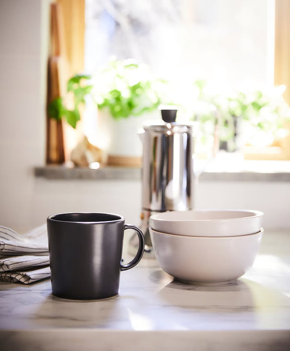  IKEA DINERA dark grey mug styled on a table in a home setting
