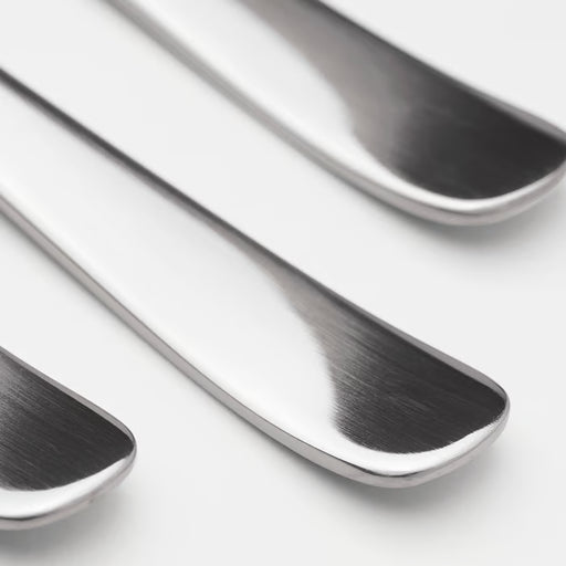 Three IKEA DRAGON polished stainless steel spoons close-up showing sleek timeless design
