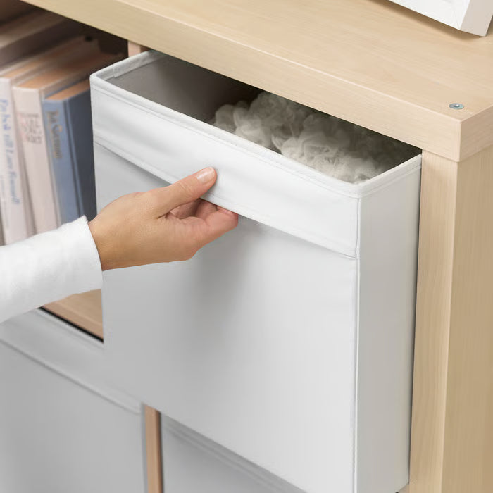 Hand pulling IKEA DRÖNA white fabric box from wooden shelf showing integrated fabric handles