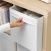  Hand pulling IKEA DRÖNA white fabric box from wooden shelf showing integrated fabric handles