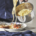 Person serving spaghetti from IKEA DVÄRGKRÄFTA stainless steel saucepan