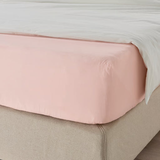 IKEA DVALA light pink fitted sheet on a neatly made bed with elastic edges securing the mattress