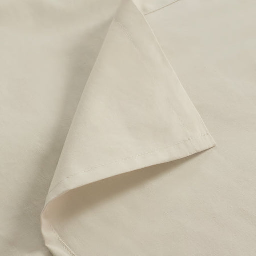 Close-up of IKEA DVALA beige cotton fabric showing fine woven stitching detail