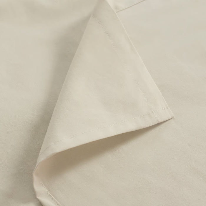Close-up of IKEA DVALA beige cotton fabric showing fine woven stitching detail