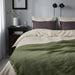 "IKEA DYTÅG soft grey-green linen-cotton blend throw blanket draped on a bed"