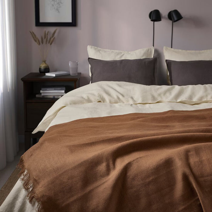 "IKEA DYTÅG soft light brown linen-cotton blend throw blanket draped on a bed"