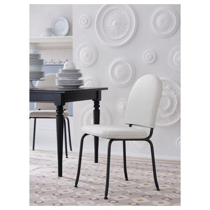 Side view of the EBBALYCKE beige chair by IKEA, showing its compact stackable design and ergonomic shape for comfortable seating.