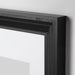 Close-up of IKEA EDSBRUK black stained frame showing fibreboard construction and plastic front protection