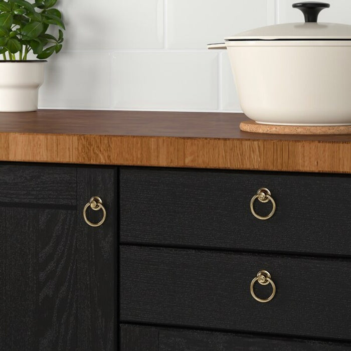 IKEA EDVALLA Brass cabinet knob being installed on a kitchen drawer, highlighting its stylish appearance- pack of 4 -80347889