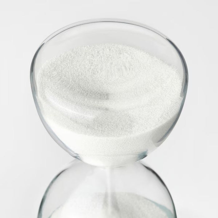 A classic hourglass with white sand and a black metal frame, ideal for adding a decorative element to your home.