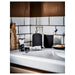 IKEA EKOLN dark grey soap dish on white bathroom counter with chrome tap and tiled wall background