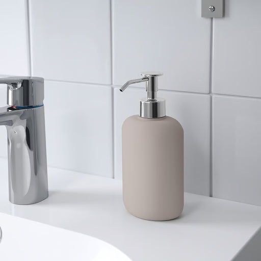 KEA EKOLN beige soap dispenser placed beside bathroom sink, styled with coordinating EKOLN accessories