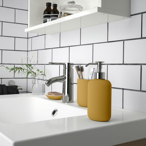 IKEA EKOLN dark yellow soap dispenser styled on modern bathroom sink countertop