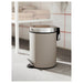 IKEA EKOLN beige cylindrical waste bin with foot pedal beside white toilet