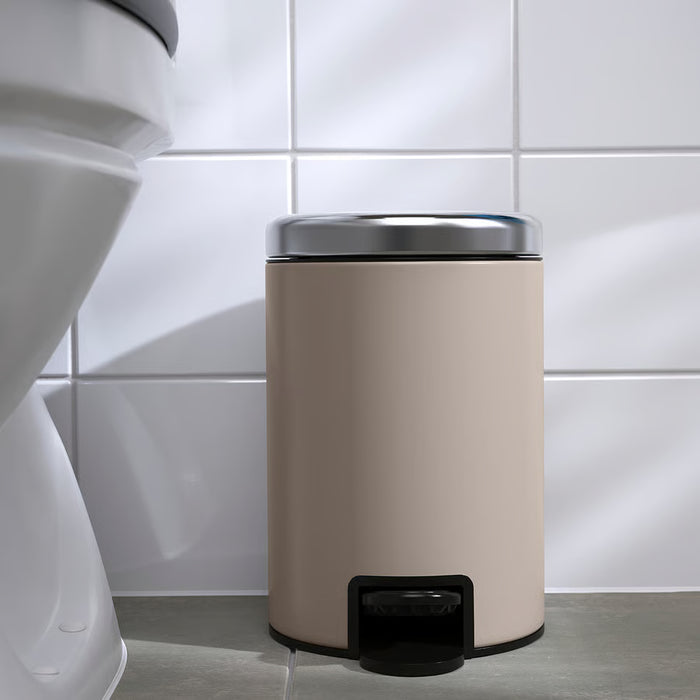 IKEA EKOLN beige waste bin placed in a bathroom corner