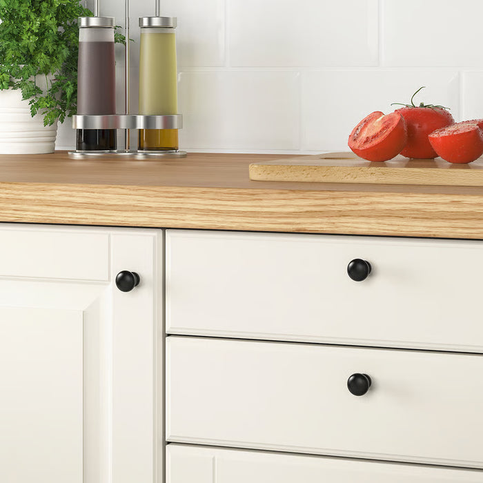 IKEA ENERYDA black knob installed on kitchen drawer with wooden countertop
