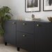 IKEA ENERYDA brass knobs and handles on modern black cabinet styled with books and a large plant