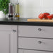 IKEA ENERYDA chrome knobs on white sideboard styled with candles and plant