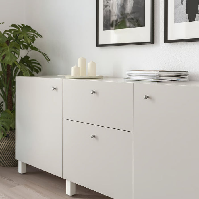 IKEA ENERYDA chrome knobs installed on grey kitchen cabinets modern interior