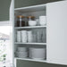 IKEA ENHET white wall cabinet with adjustable shelves holding cups, glasses, bowls and jars