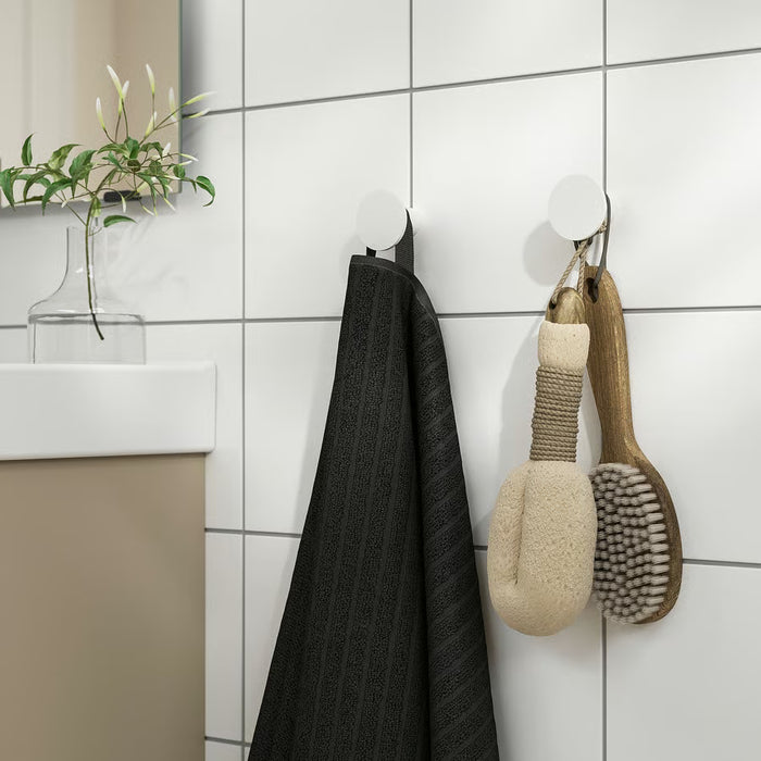 IKEA ENUDDEN white hook mounted on bathroom wall with towel hung in use context